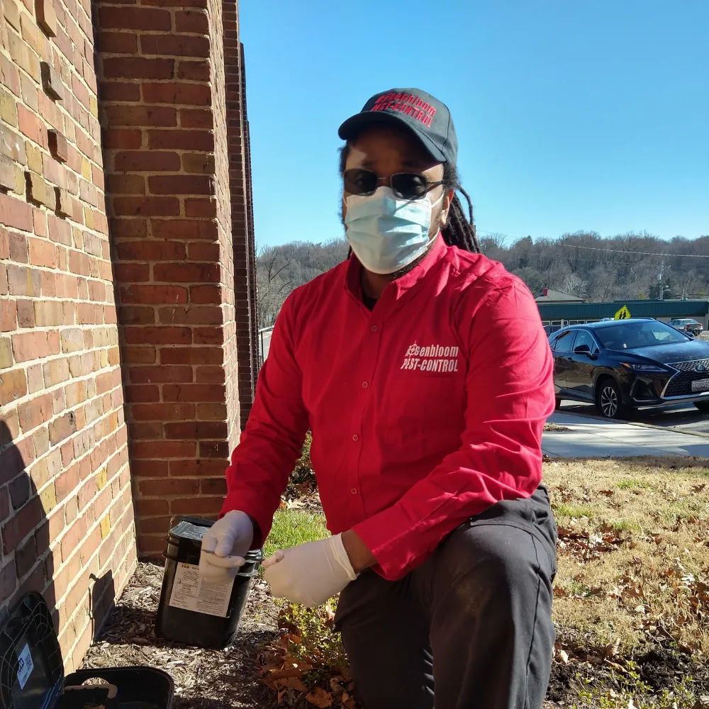 pest control tech doing perimeter treatment